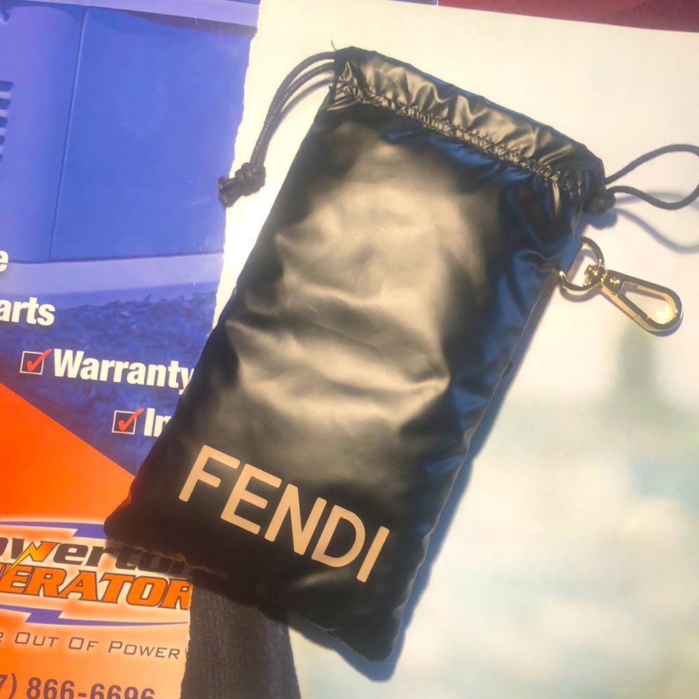 Fendi puffy drawstring accessory bag with brass clip, like new, 8” x 4”